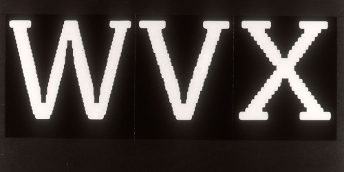 White characters on black read WVX, with jagged diagonal strokes